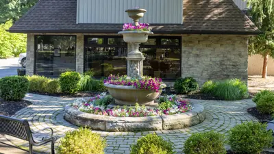 The cemetery administration building and the Queen Victoria floral fountain at Fairview Cemetery in Niagara Falls Ontario.