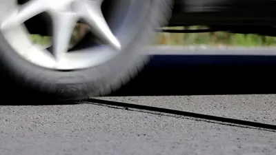 Car tire running over car counter