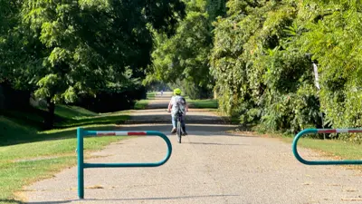 A child riding their bicycle on the Haulage Road Trail in Niagara Falls.